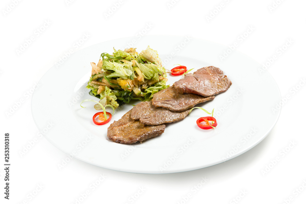 Salad with beef on a white plate