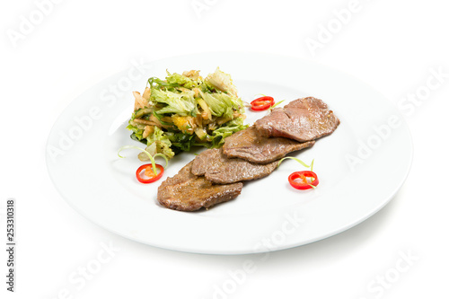 Salad with beef on a white plate