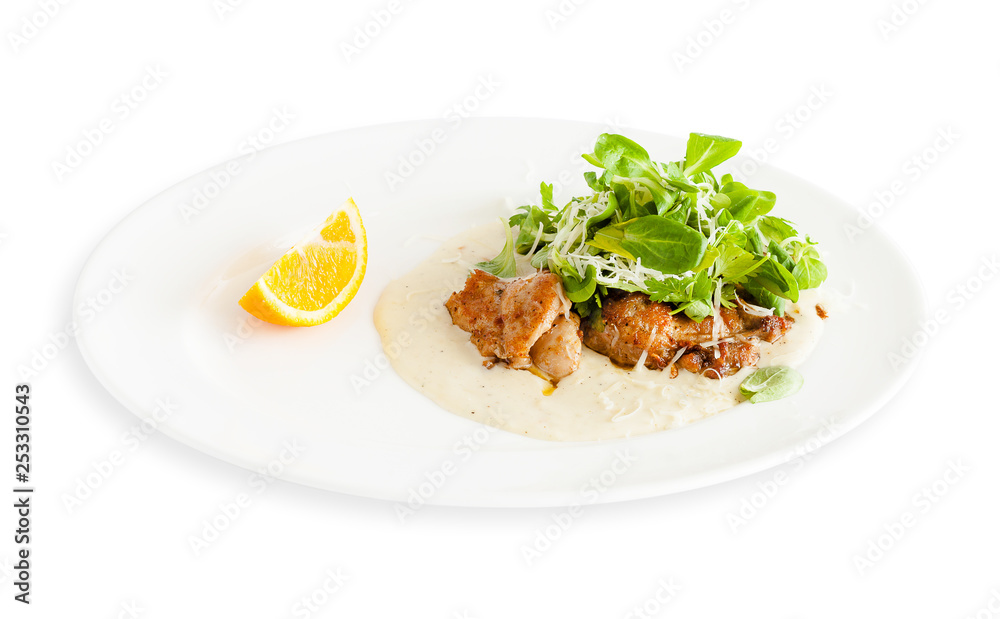 Fried meat with herbs and lemon on a plate