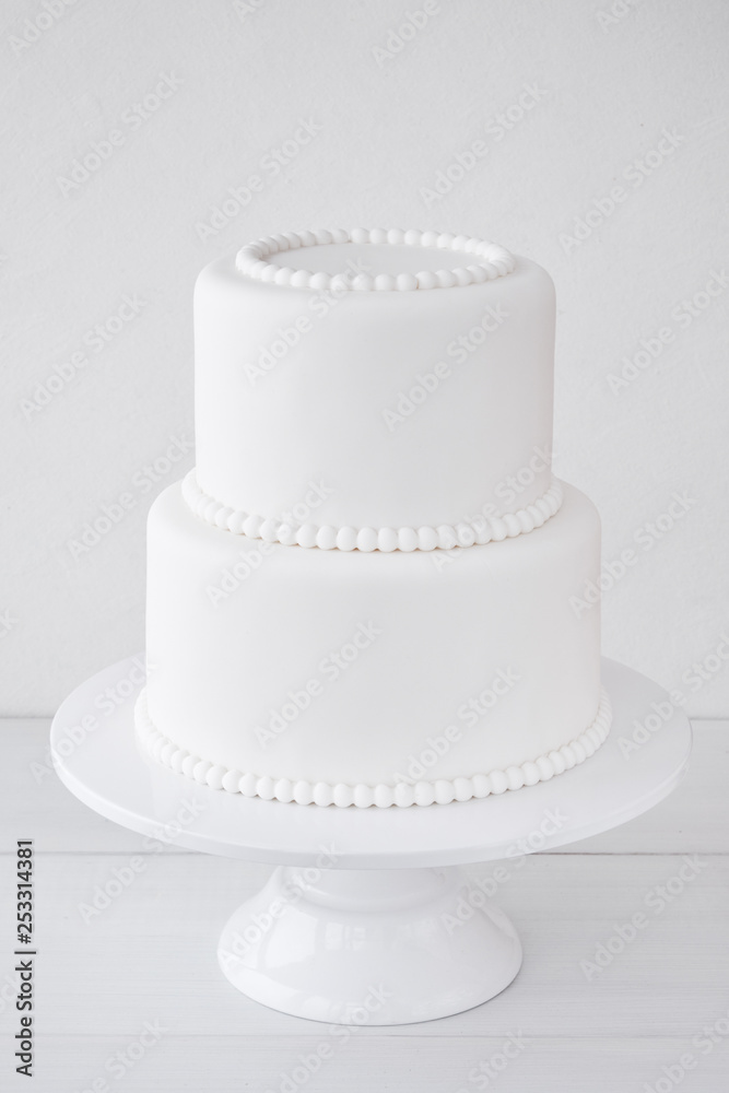 White wedding cake blank on a white background. Simple minimalism. White wedding cake blank on a white background. Simple minimalism.