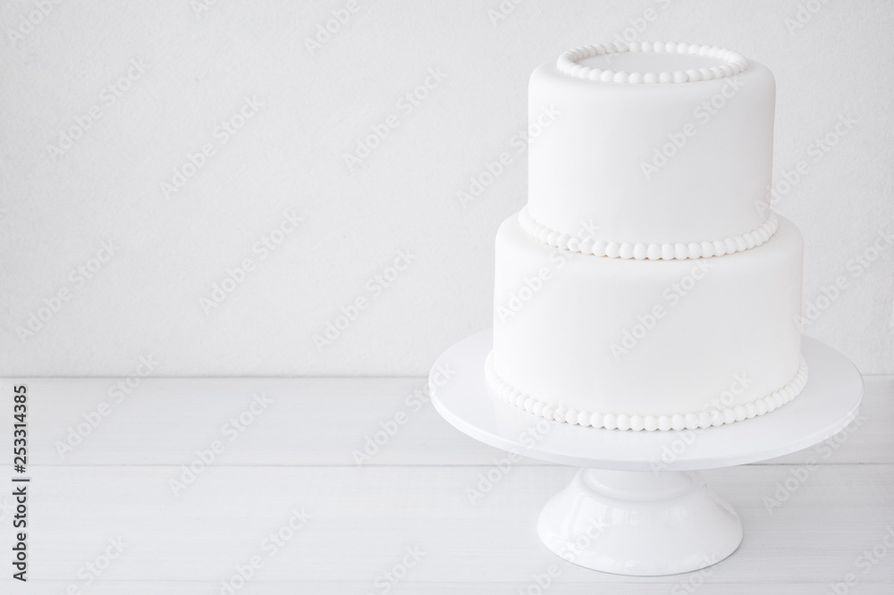 White wedding cake blank on a white background. Simple minimalism. White wedding cake blank on a white background. Simple minimalism.