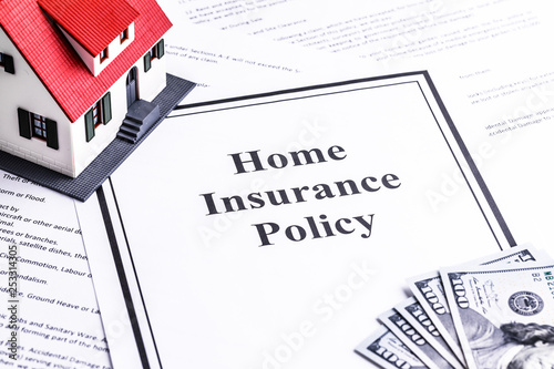 Close-up of a house model with dollar notes. Mortgage concept. Home insurance policy