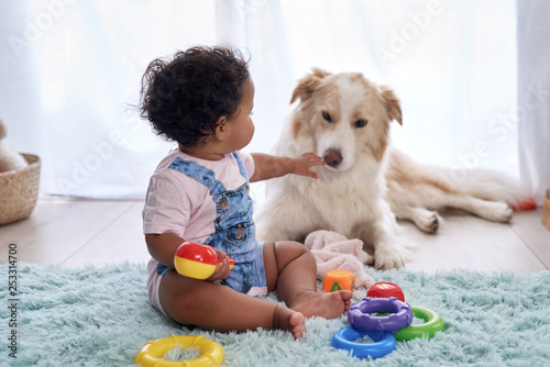 Baby with family dog on the floor