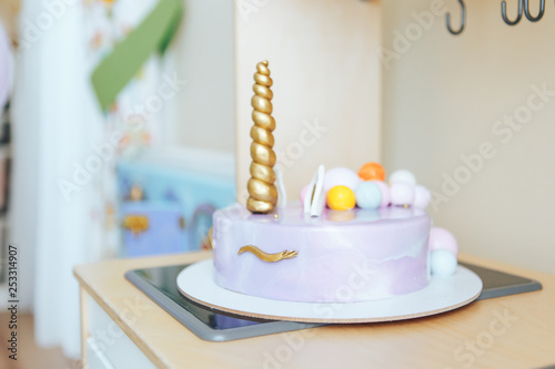 Beautiful homemade cake in the form of a unicorn on a wooden table