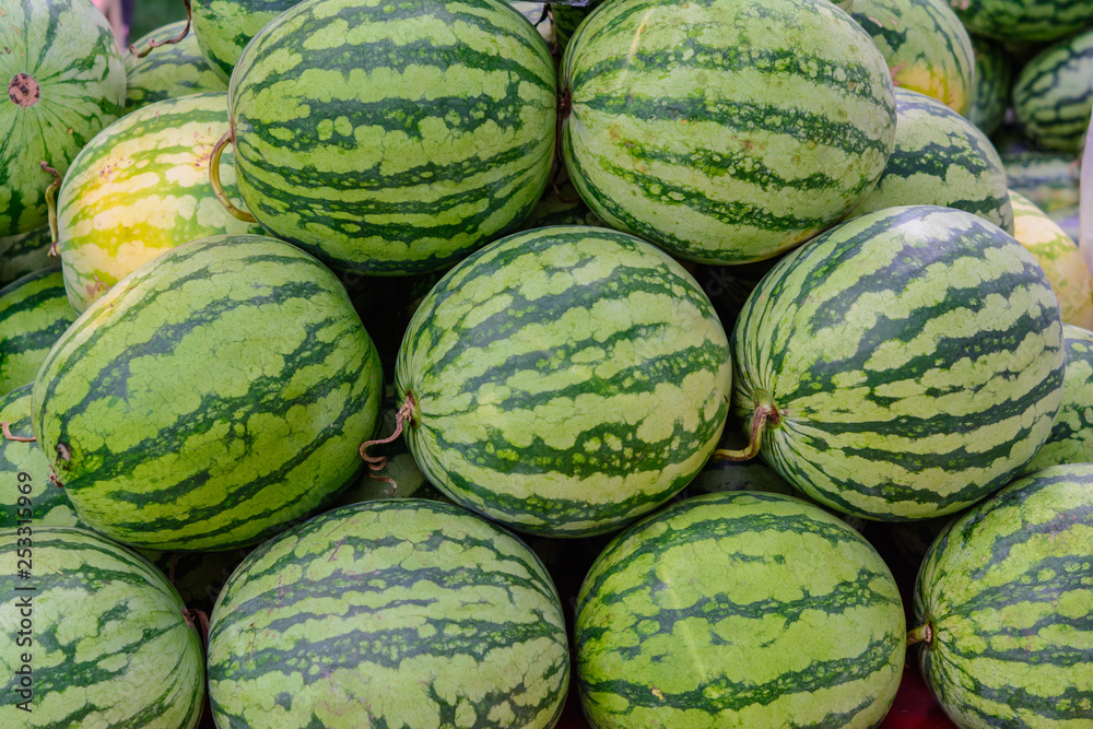 Green watermelon in a market waiting for sale. Fruit watermelon background
