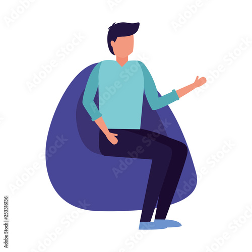 man sitting on beanbag chair