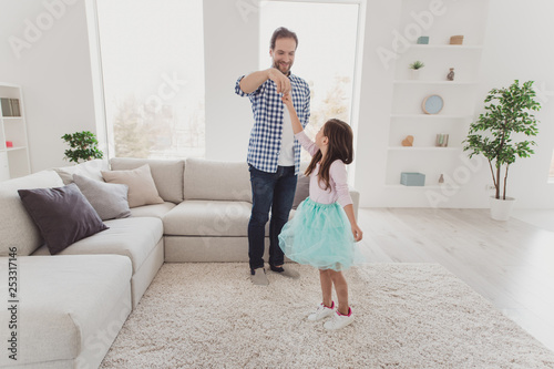 Full length body size view of nice lovely attractive cheerful talented stylish elegant pre-teen girl learning practicing training moves with daddy in modern light white interior room indoors