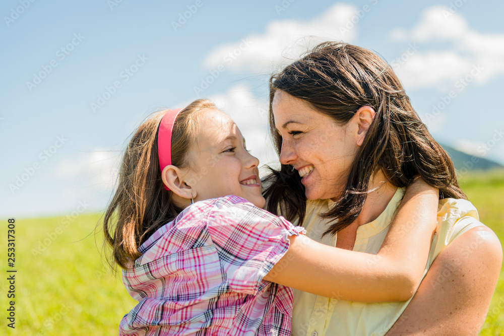 Authentic moment of mther and daughter hugging Authentic moment of mther and daughter hugging