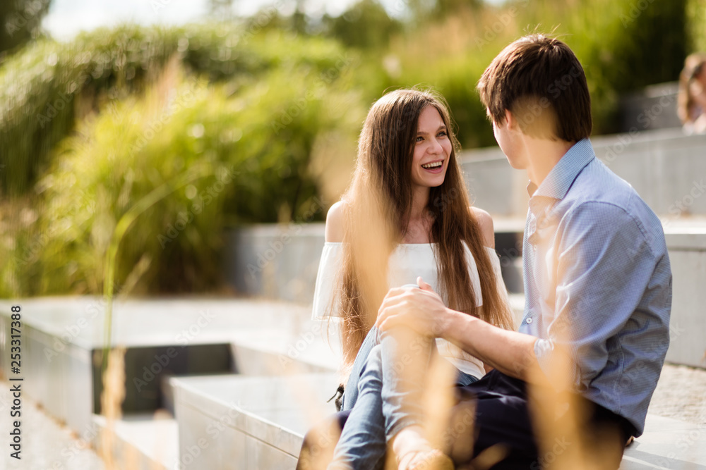 Romantic love fun couple sitting outside in park Romantic love fun couple sitting outside in park