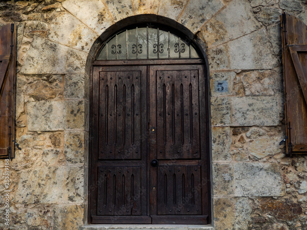 Old door in a building with a stone wall Old door in a building with a stone wall