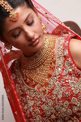 Indian bride in traditional bridal sari in studio lighting indoor