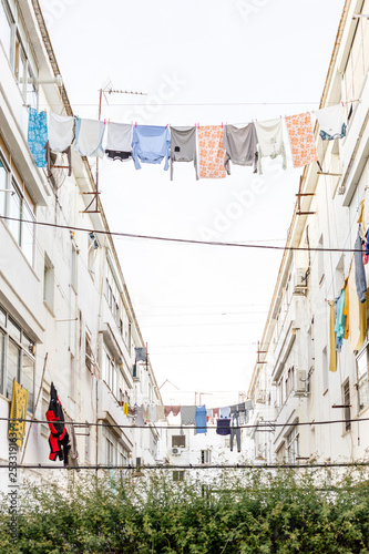 Washed clothes hanging between residencial buildings in Ayamonte,  Andalusia, Spain  photo