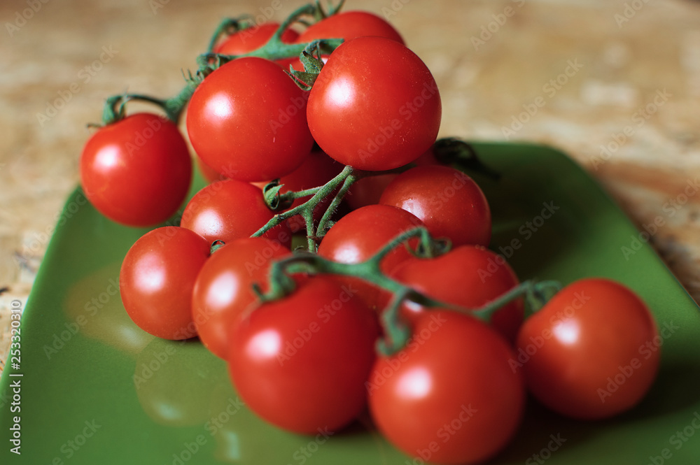 red cherry tomatoes on a branch