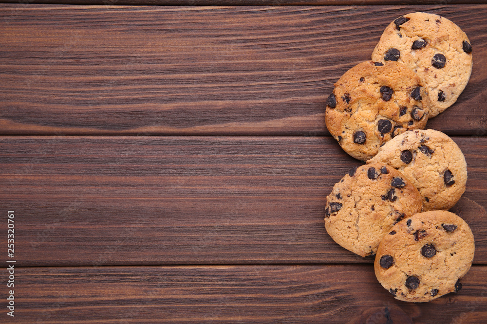 Chocolate cookies on brown background. Chocolate chip cookies shot Chocolate cookies on brown background. Chocolate chip cookies shot