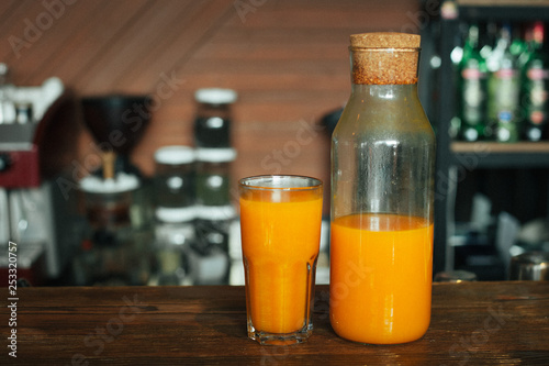 sea buckthorn juice in glass and jug