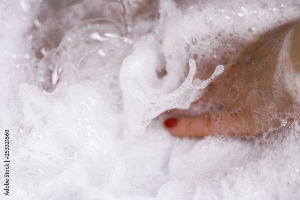 The hand foamed with soapsuds during the washing. The hand foamed with soapsuds during the washing.