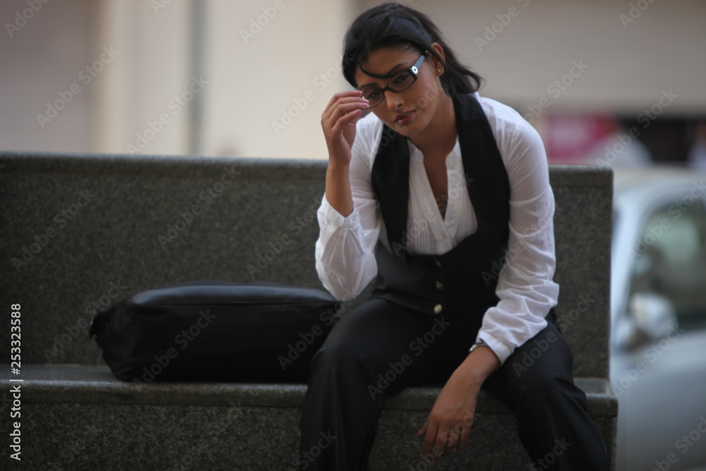 Beautiful business lady in corporate suit posing outdoor wearing spectacles outdoor - Image Beautiful business lady in corporate suit posing outdoor wearing spectacles outdoor - Image