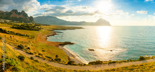 View of mountains and blue sea in the Italian natural reserve or Riserva dello Zingaro at sunset lights in Sicily, Italy