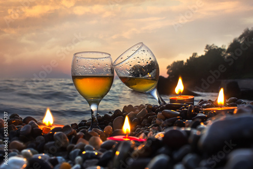 Romantic dinner with candles at sunset.