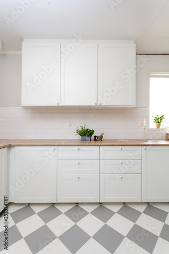 clean kitchen counter top with white cupboards