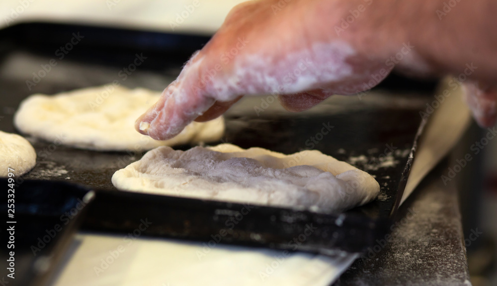 Production of baked bread with a wood oven in a bakery.