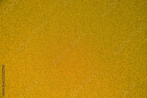 An abstract golden background made of twinkling glitter that is great for a background for Christmas and other celebrations.