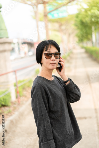 Asian woman talking on cellphone © ChenPG