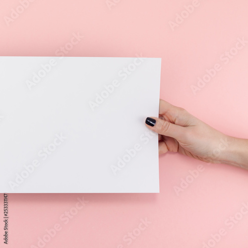 Woman hands with blank A4 paper sheet mockup