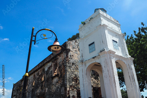 Lamp post near ruined architecture