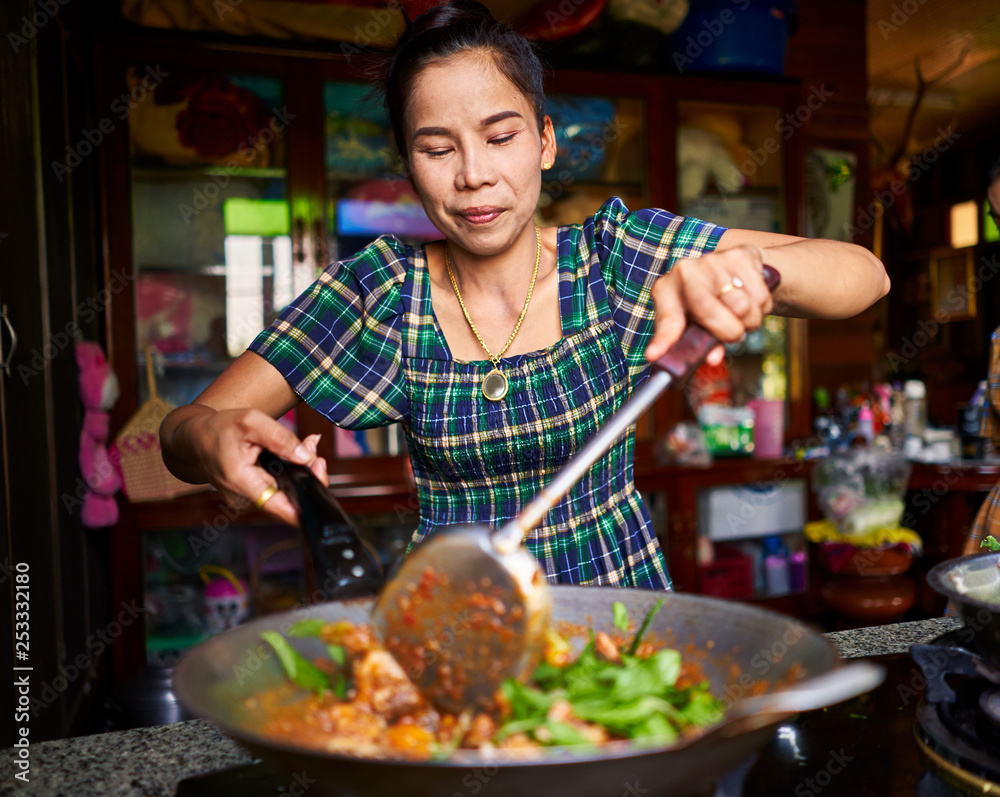 thai woman cooking traditional red curry in wok Stock Photo | Adobe Stock