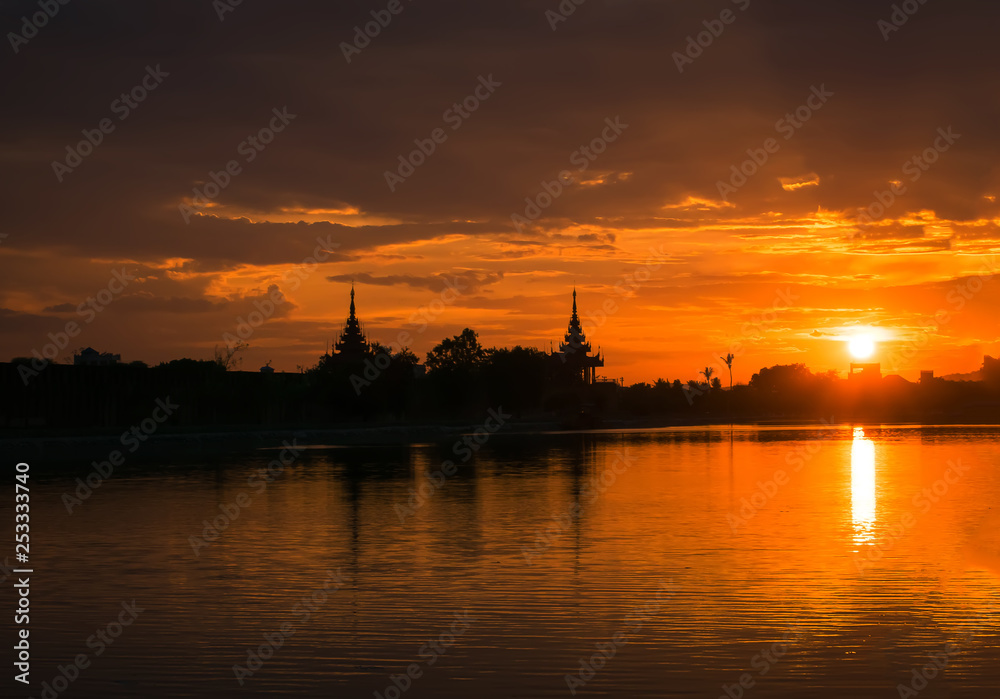  yellow and orange sky above it with  sun golden  . Amazing summer sunset view with beautiful Temple of Thailand.