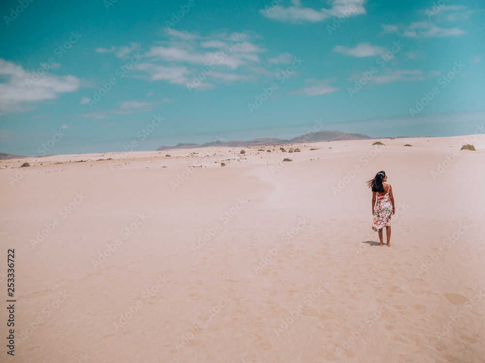 a brunette woman walking on the sand in summer a brunette woman walking on the sand in summer