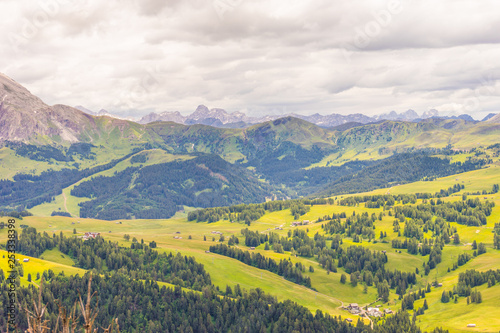 Alpe di Siusi  Seiser Alm with Sassolungo Langkofel Dolomite  a large green field with a mountain in the background