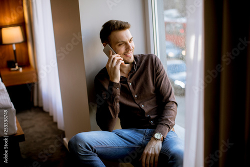 Young man using mobile phon...