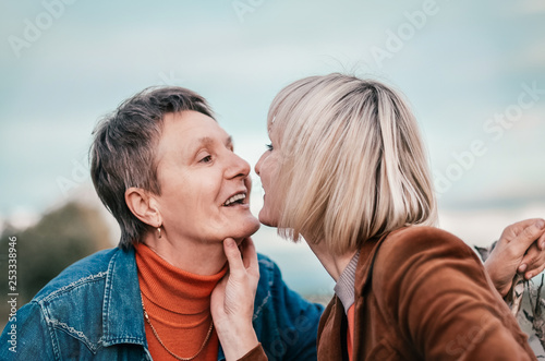 Elderly mother tenderly kissing his daughter. Concept - Maternal love and family