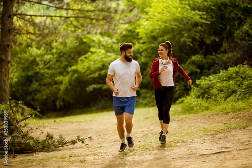 Healthy fit and sportive couple running in nature