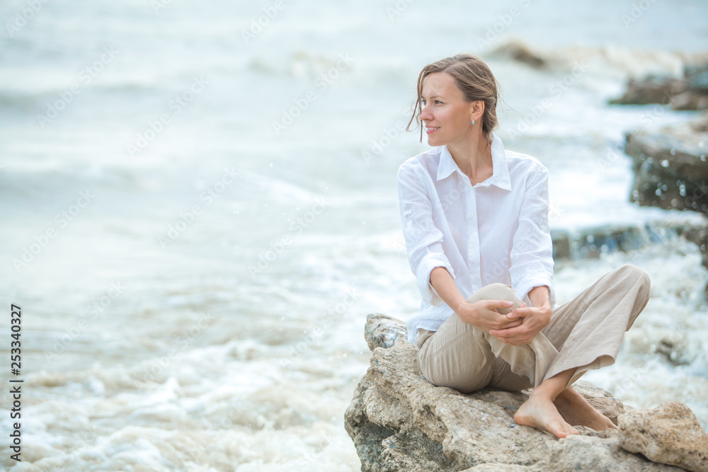 Young woman enjoying life on the ocean coast