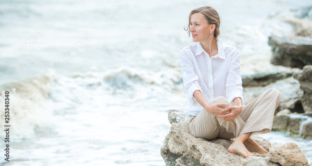 Young woman enjoying life on the ocean coast