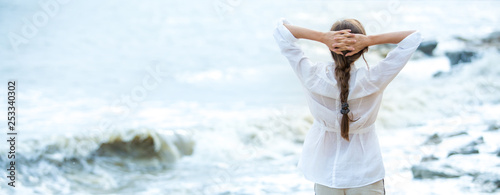 Young woman enjoying life on the ocean coast photo