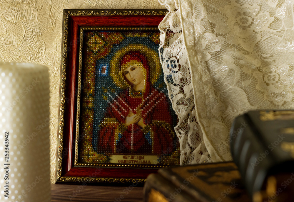 Obraz premium The concept of religion. View of the icon. the Bible is next to it and there is a white candle