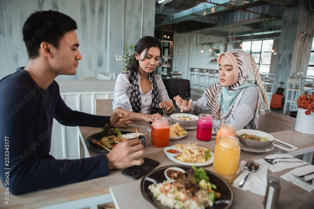 group of friends enjoy eating together in a restaurant