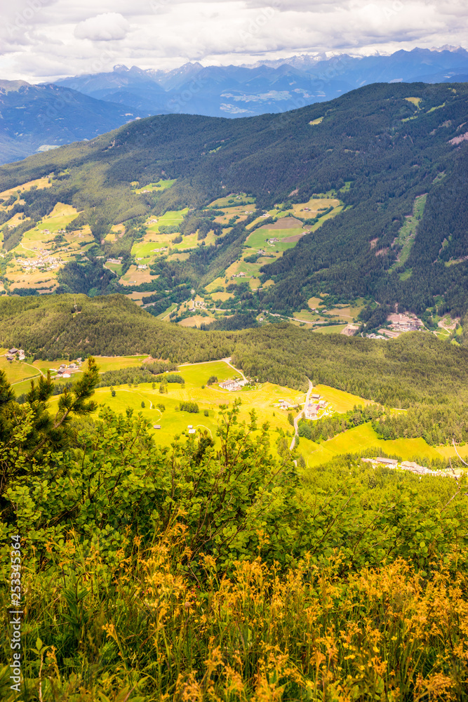 Alpe di Siusi, Seiser Alm with Sassolungo Langkofel Dolomite, a large green field with a mountain in the background