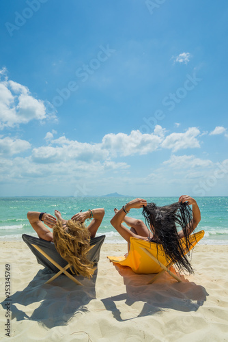 Fototapeta Naklejka Na Ścianę i Meble -  Two Women enjoying their holidays on the tropical beach