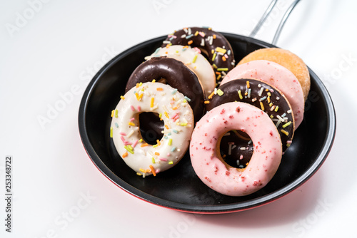 Donuts and drink and iron frying panon white background top view copy space pattern photo