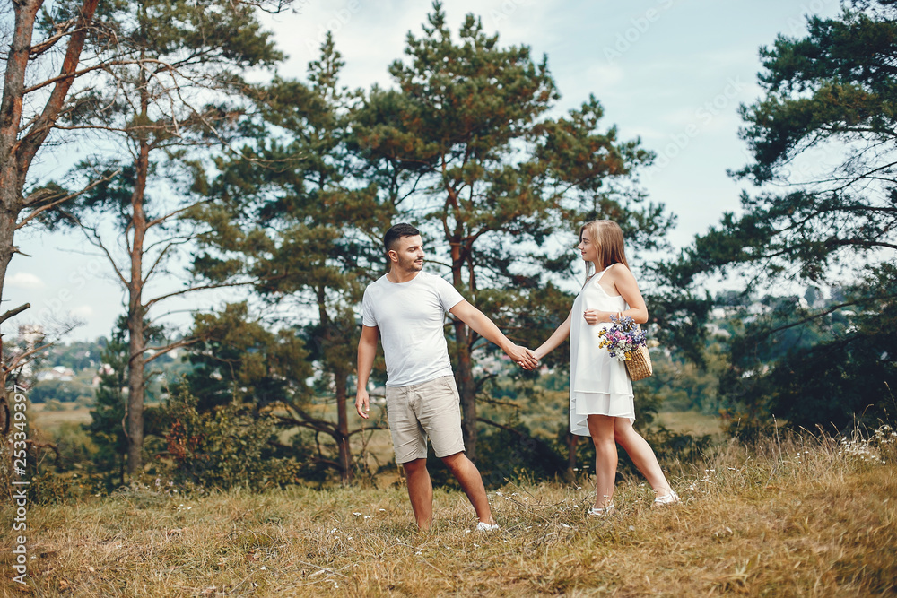 Beautiful couple spend time in a summer park