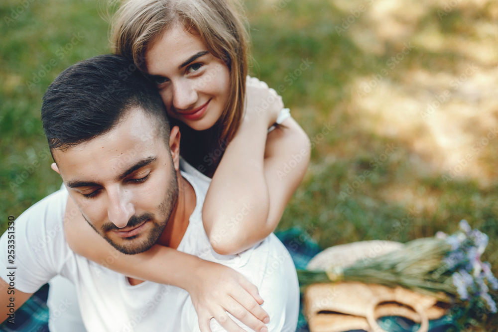 Beautiful couple spend time in a summer park Beautiful couple spend time in a summer park