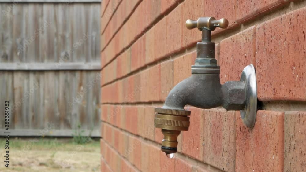 Leaking faucet turned off by a white male. CLOSE UP SHOT. LOCKED OFF SHOT. Leaking faucet turned off by a white male. CLOSE UP SHOT. LOCKED OFF SHOT.