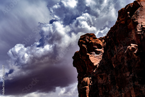 Storm clouds over the red rock of Lake Powell, Utah with white and grey clouds, blue sky