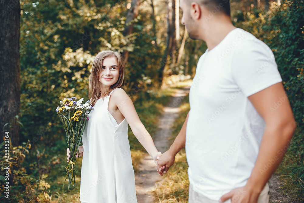 Beautiful couple spend time in a summer park Beautiful couple spend time in a summer park