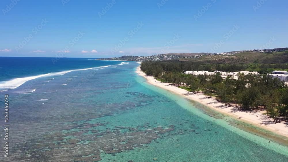Aerial view over the coast of Reunion Island with corareefs under the turquoise water on a sunny day. Aerial view over the coast of Reunion Island with corareefs under the turquoise water on a sunny day.